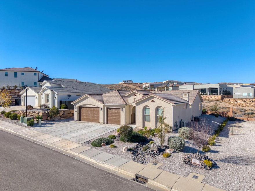 Enjoy breathtaking views from this beautifully designed home in the sought-after Divario community. A private 310 sq ft casita with separate entrance offers the perfect space for guests, a home office, or multi-generational living. The main home features a spacious 3-car garage and an inviting courtyard with fireplace. With a natural desert corridor directly behind the property and low HOA fees, this home combines privacy, flexibility, and exceptional views in one outstanding location.