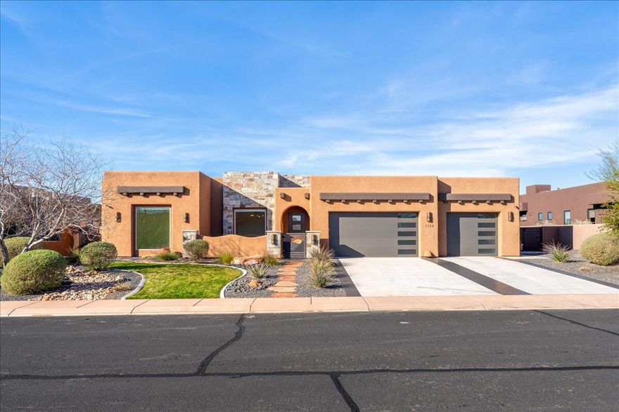 This exceptional 4 bedroom, 2.5 bathroom home is perfectly positioned in Sand Hollow, backing directly to the golf course and packed with high-end upgrades that elevate both everyday living and entertaining. From the private front courtyard entry to the resort-style backyard, every detail has been thoughtfully designed to blend luxury, comfort, and function.

Inside, the open-concept layout is filled with natural light and anchored by a stunning great room with soaring ceilings, exposed beams, and expansive windows that frame peaceful fairway views. The kitchen is a true centerpiece, featuring Taj Mahal quartzite countertops, an oversized island, custom cabinetry, premium appliances, and designer lighting. A custom wet bar with floating shelves and accent lighting adds a sophisticated touch, making hosting effortless.

The primary suite is a serene retreat with backyard and golf course views, a spa-inspired en suite with dual vanities, soaking tub, walk-in shower, and a generous walk-in closet. Three additional bedrooms offer flexibility for guests, office space, or hobbies, while the secondary bathrooms showcase modern finishes and clean, timeless design.

Step outside to your private backyard oasis with a covered patio, pool, manicured landscaping, and uninterrupted views of the golf course, perfect for relaxing afternoons or evening gatherings. The home also features an oversized garage with epoxy floors, 240V power, and a bonus room at the back of the garage ideal for a gym, workshop, or additional storage.

Located just minutes from Sand Hollow Reservoir, golf, off-road recreation, and Southern Utah's iconic red rock scenery, this home delivers luxury living with a prime golf course backdrop and an impressive list of upgrades that truly set it apart.