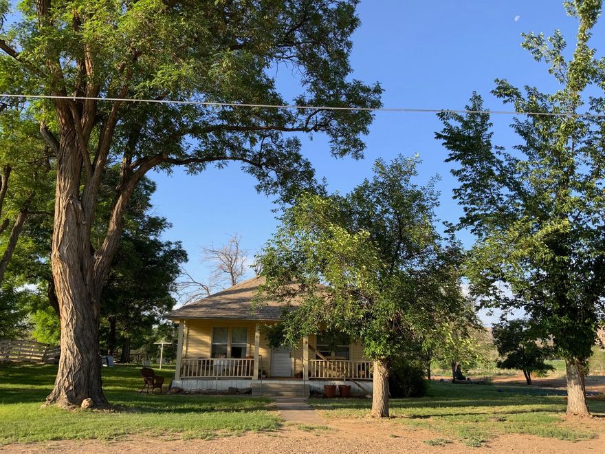 Welcome to this sweet country home situated on a hard to find 1.76-acre corner lot in town. Lots of room to roam, beautiful mature trees, scenic views and the simple beauty of country life. Lovingly preserved and thoughtfully updated, the owner has maintained the home's original charm while creating a warm and comfortable retreat ideal for weekend escapes or full-time living. Some of the renovations include interior rooms finished with  ''American Clay'' to give a pleasant, warm look, newer LVP flooring & exterior paint. Well-maintained kitchen with original cabinetry, and a large laundry room with tons of natural light;  would make a great craft room or office. Inviting front porch to enjoy gorgeous views over the Escalante Canyons, especially after a day of hiking and exploring the area with world-class recreation all around.  1 Share of Irrigation water included, 2 parcels being sold together. This is the one you've been waiting for!