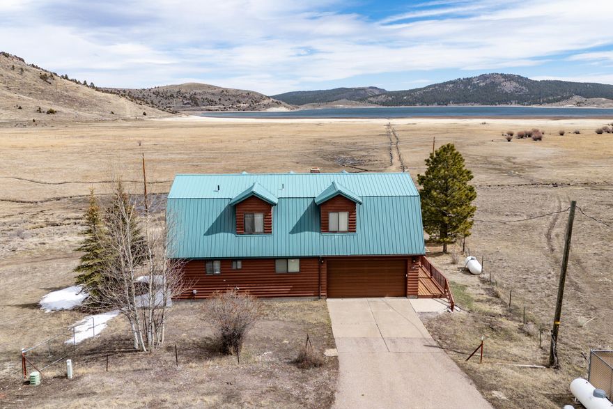 This 3,748 sq ft cabin sits on 0.25 acres along the edge of Panguitch Lake, offering a great location for enjoying the outdoors and everything the lake area has to offer. The 1,430 sq ft main floor includes a kitchen, living room, laundry room, one bedroom, and a full bathroom. Upstairs features another 1,430 sq ft with an open family room, three bedrooms, and a second full bathroom. The 888sq ft basement is partially unfinished and provides outside access along with shelving and plenty of storage space.
The property also includes a two-car garage with an attached workshop room, offering additional space for projects or storage. The cabin has been recently stained and includes a backup Generac generator for power outages. Lawn mower and plow are negotiable.