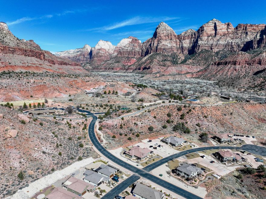 Your Zion Retreat awaits!! Tucked in the tranquil Moenave Community, in the heart of Springdale, Utah, just ½ mile from the entrance of Zion National Park. This home offers stunning, unobstructed 360 degree towering red rock views, including The Watchman, Three Mary's, Cowboy Ridge & Bridge Mountain.

Expansive windows and 9' ceilings add to the spacious open floor plan. Natural light and breathtaking views pour into every room.  9' ceilings and the open concept plan make for an inviting, spacious gathering area. . The kitchen features a large island, upgraded knotty alder cabinetry throughout, with above and under cab accent lighting, granite countertops, subway tile backsplash, and stainless steel appliances. Luxury Vinyl Plank flooring flows throughout the main living areas, complemented by Recessed Lighting and Craftsman Style Casing. Bathroom finishes include tile flooring & shower surrounds with glass doors, and alder vanities with granite tops.

The pergola covered back patio off the dining area creates a charming outdoor living space with a stunning red rock backdrop. You simply cannot beat the peaceful beauty that is Moenave.

Not only is this home and its surroundings gorgeous, but it is also built with high-quality, energy-efficient features, including 2x6 exterior walls, blown-in insulation (R50 attic / R23-25 walls), Low-E windows, a 95+% efficient furnace, and a tankless water heater, offering the best of comfort and sustainability.
Walking distance from Springdale's many shops, eateries and countless, stunning hiking, biking, kayaking, option, this home is the perfect blend of luxury, convenience, and breathtaking, natural beauty. Everything you dreamed your Zion Retreat would be, and more!

Springdale does not allow overnight rentals. Long term rentals are allowed at a minimum of 60 days. All information believed to be accurate and provided as a courtesy only. Buyers to verify all.