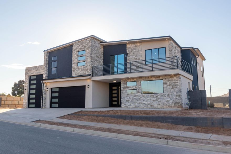 Brand-new modern 2-story by Next Level Homes on an elevated lot with red rock views. 3,700+ sq ft, RV garage, main-floor guest suite, big great room + butler's pantry. Upstairs primary w/ sitting area, loft w/ kitchenette plumbing, and view deck.