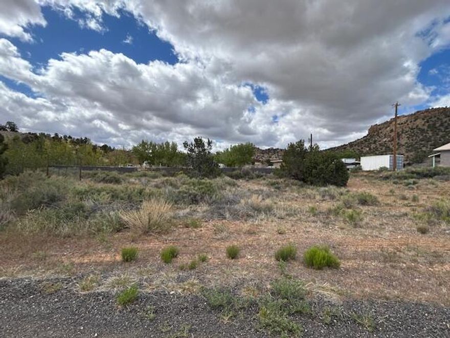 Gorgeous views of Escalante Canyons!  Almost 1/2 lot situated at north end of town near the River and located at end of road.  North facing with all utilities nearby and in street.  Water meter / impact fee has been paid for. Bring your own builder with no HOA or CCR's. Partial fencing on back and side.