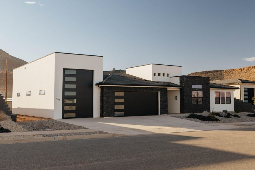 Brand-new modern Rambler in Washington! 3,280 sq ft, 4 beds, 3.5 baths, huge great room, quartz finishes, panoramic door to covered patio. Large 1/3+ acre lot with RV garage. Guest suite w/ private entrance. Close to town with red rock views.