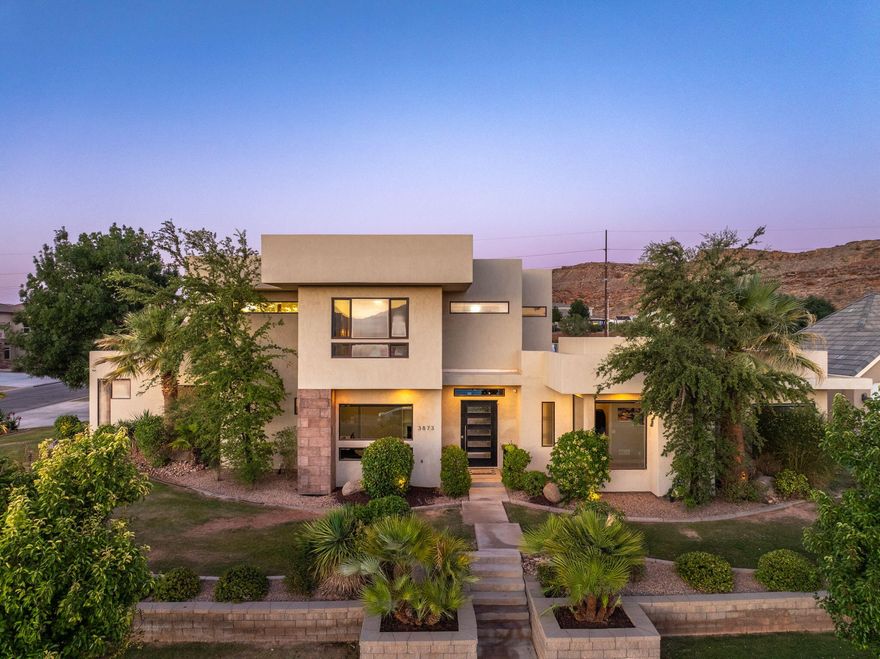 Beautiful home in Meadow Valley Farms with no HOA, located on a spacious ½-acre corner lot in an established, friendly neighborhood near Little Valley Elementary, Sunrise Ridge Intermediate, and Desert Hills High School—plus just minutes from parks and the popular BYU Creamery Alumni. Bright and airy with vaulted ceilings and an open-concept layout, this home features a chef's kitchen with double dishwashers, Viking cooktop, hidden pantry, and floor-to-ceiling cabinetry. You'll love the large mudroom, oversized laundry room, and smart features like surround sound, central vac, instant water heaters, and an 8-camera Reolink security system (alarm wired). The primary suite includes a walk-in shower, garden tub, makeup vanity, and a huge walk-in closet. The basement offers a theater room, home gym, extra bedrooms, and generous storage. Enjoy seamless indoor/outdoor living with sliding glass doors, a 600 sq/ft covered patio, 40' x 20' saltwater pool/spa, electric pool cover, and outdoor shower. The fully fenced yard features lush grass, mature landscaping, and landscape lighting. A 4-car garage with built-ins completes this amazing home in one of St. George's most desirable communities.