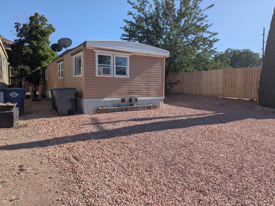 Great value! Cute starter home or investment property that comes with electric fireplace and all appliances shown. Mulberry tree provides beauty and shade. Newer wood fence provides privacy. Includes storage shed. Vacant and ready for a new owner to love! Mobile home only - no land is included. Must pass credit and background check in order to live in Pecan Tree Mobile Home Community. CASH ONLY.