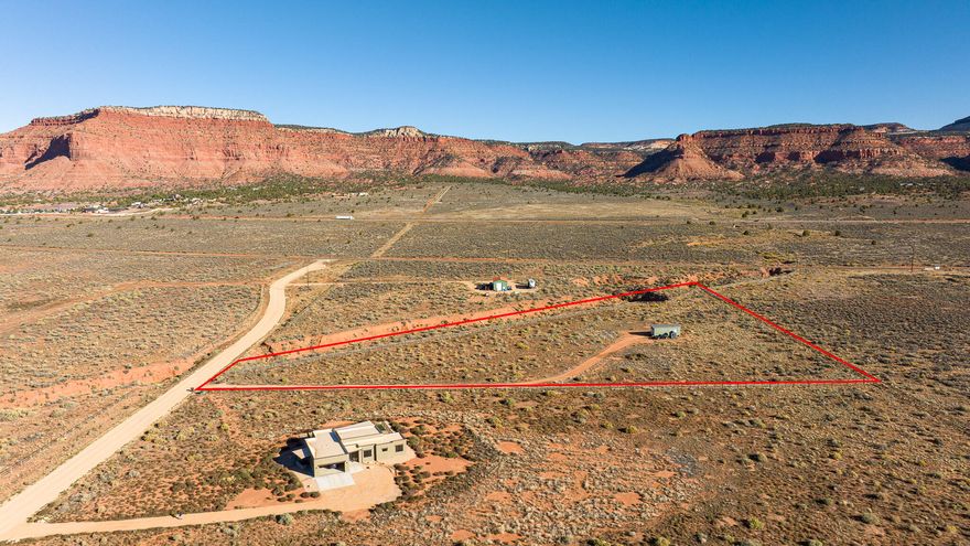 5 Acres with Sweeping Red Cliff Views- Almost fully fenced- STR-Friendly - Horse property. Already has a Driveway, septic, electric and water. Has had a previous RV site installed and is awaiting you to build a dream home. Experience the beauty of Southern Utah from this stunning 5-acre parcel showcasing unobstructed red cliff views and endless possibilities. The 1,500-gallon septic system is big enough to use for a home. This parcel allows two site-built homes. A single short-term rental is permitted on the property or a multi-generational home. A good option for those seeking income potential in a highly desirable area. Enjoy privacy, serenity, and the breathtaking natural scenery making this region so special - all while being minutes from town and outdoor adventure. Buyer to verify all.