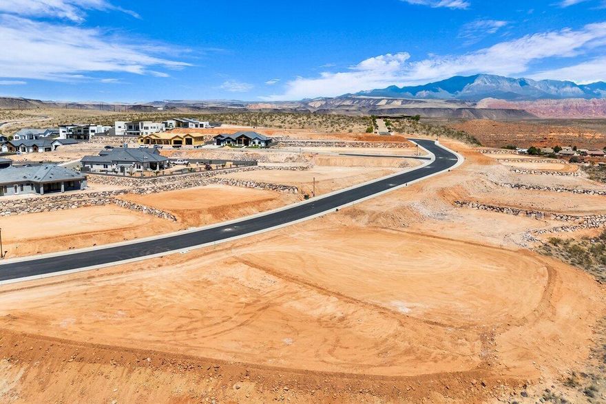 Premier rim view lot with exceptional views overlooking the city, mountains, Pine Valley, red rock mesas, Sand Hollow, and even Zion National Park! Best suited for a walkout floor plan, this lot is located in the final phase of Grand Heights, the highest elevated subdivision in St. George proper, nearly 500 feet higher than the rest of town, including Stone Cliff and Foremaster, offering unmatched views. Enjoy quick access to downtown, hiking and biking trails, and off-road adventures, plus you're just 15 minutes from two major fishing reservoirs and over half a dozen top-rated golf courses. With BLM land bordering the subdivision, you can ride bikes and ATVs straight from your doorstep. Numerous oversized lots are available with convenient highway access. Bring your own builder! Buyer is responsible for water impact fees. All construction requires prior review and approval by the architectural control committee. Buyer to verify all information, deemed reliable, however buyer to verify all info including utilities & ACC information if applicable.