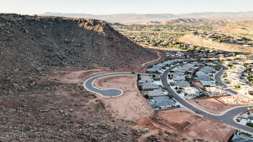 THIS LOT IS A MUST SEE! Large building lot with incredible mountain views and city lights. Walk-out lot. Build your dream home on this cul-de-sac lot in the last phase of the prestigious Cottam Cove development. Bring your own builder and take advantage of this unique opportunity. Come fall in love with this neighborhood tucked away but yet minutes to town, schools, hospital and shopping. A custom home subdivision and low utility costs with Dixie Power.  Great soils with all the engineering finished with stamped approvals on all lots.  Home plans subject to ACC approval. ALL INFORMATION HERIN IS DEEMED RELIABLE BUT IS NOT GUARANTEED. BUYERS AND BUYERS AGENT ARE TO VERIFY ALL INFO.