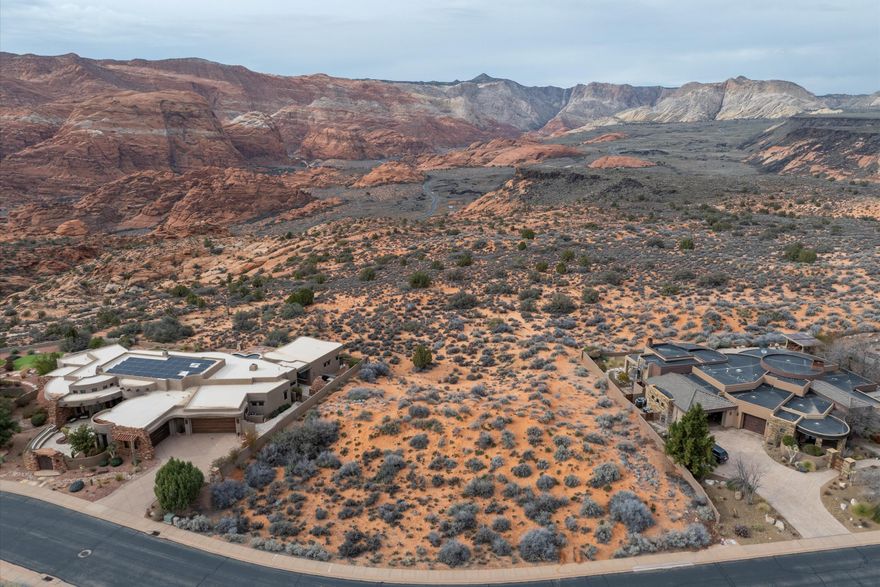 Rare opportunity to own one of the final premier rim lots backing directly to Snow Canyon State Park. This .59-acre parcel provides a private, unobstructed vantage point over iconic red rock cliffs, ancient lava flows, and sandstone formations. Located within the secure, gated Ledges community, the property offers a protected natural backdrop that ensures no future development will ever mar your views. The flexible topography perfectly suits a sleek single-level ranch or a sophisticated multi-level estate with a walk-out basement. Enjoy elite resort living with access to the 18-hole championship golf course, clubhouse, and miles of hiking and biking trails. Secure your place on the rim where the landscape defines your lifestyle. Call/text listing agents for viewing instructions.