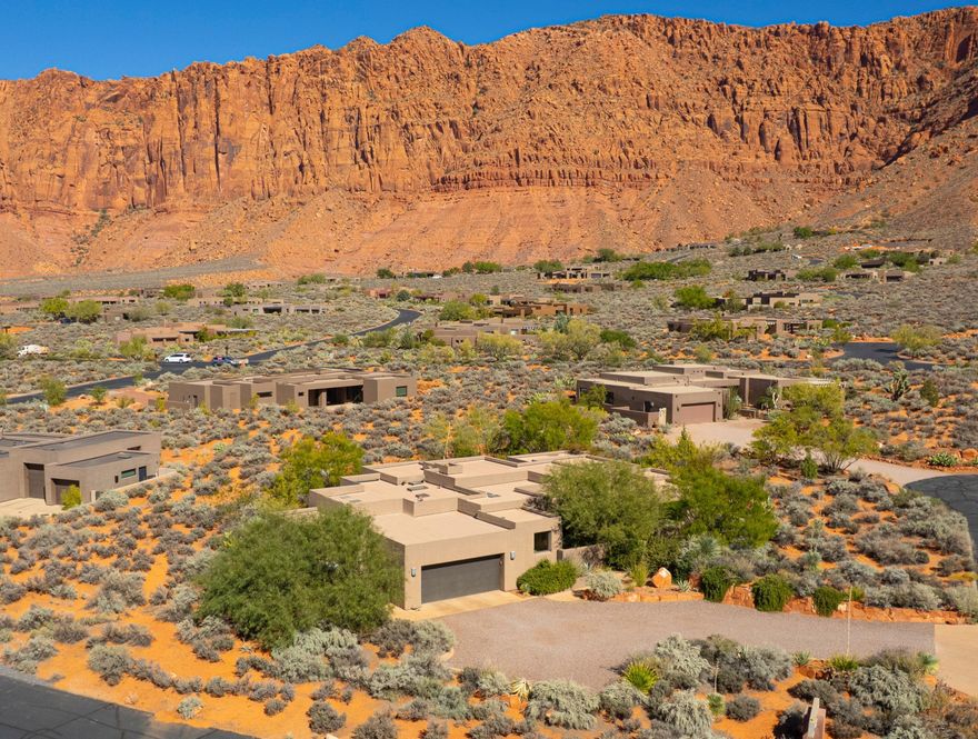 This Kayenta home truly celebrates all that Kayenta has to offer.  Form and function converge in this open-concept floor plan, and the lines are blurred between indoor and outdoor living spaces. The home is both elegant and comfortable.  There is a guest suite and a third bedroom (or office?) with patio access to the lushly-landscaped outdoor gardens and living spaces.

The primary bedroom, boasts a steam shower, soaking tub, double vanity, walk-in closet and built-in dresser.
Solid core wood doors and cabinets throughout the home, gas fireplaces, an outdoor spa, gas grill hook up, outdoor shower, central vac, separate laundry/craft room off of the garage. The kitchen is equipped with Subzero and Wolf appliances. The 3-car garage has a tandem parking space with its own internal car door. This 3rd parking space has a mini split A/C and heating unit. There is a half bath with utility sink within this space. It was originally built as an art studio. There is also a large storage room  within this space, and a door to the outside living area and patios.
Also, there is an outdoor shower near the spa.

476 offers privacy and seclusion within its mature landscaping situated majestically beneath towering red cliffs yet is just a short distance to the cultural, culinary and retail offerings of the renowned Kayenta Art Village.  Come see this very special home for yourself.