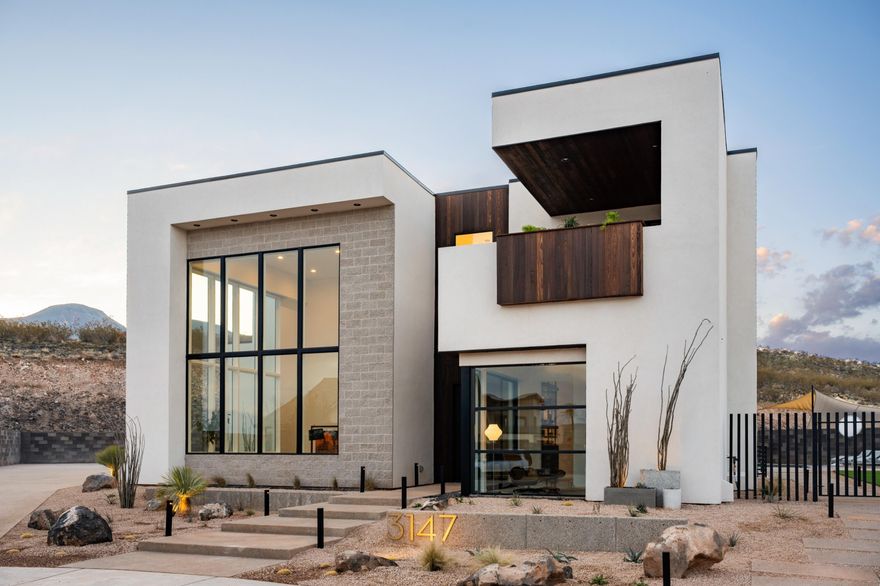 Experience the epitome of modern luxury in this 2023 Parade Home, a custom masterpiece blending mid century charm with Scandinavian elegance. Nestled on a secluded .35 acre lot at the end of a cul de sac, this 5 bedroom, 6.5 bath home offers unparalleled privacy, backing to a scenic hillside. The dramatic great room commands attention with its 22 ft ceilings and expansive wall of glass, flooding the space with natural light. The gourmet kitchen is a culinary haven featuring a large island with butch block seating, elegant walnut accents, premium appliances and a built in banquette. Descend to the lower level, where a full bar, theatre room and music room offer endless possibilities for leisure, with ample space for entertaining . The upper level of the home is segmented into two quadrants, the primary suite is a serene retreat with a private deck, spa inspired bath with custom soaking tub entirely tiled in Japanese porcelain,
a generous walk in closet and an adjacent gym with direct patio access. The other half of the upper level holds three ensuite bedrooms and a bonus room dedicated to this side of the home. 

Outside the resort style grounds feature a custom pool with recessed firepit and seating section, double sized hot tub and a climbing wall. The garage includes 5 spacious bays, 4 bays accommodate recreational gear, providing ample parking and storage space. Every detail is elevated with designer finishes, meticulous architectural design and an unwavering attention to detail, making this home a rare and exquisite masterpiece.