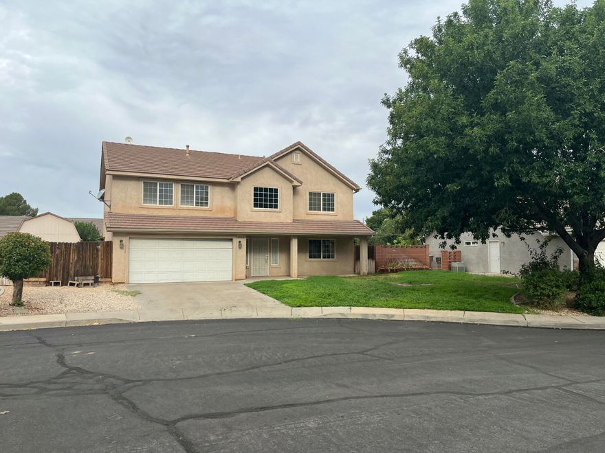Seller is offering $10,000 in seller concessions! This 2,854 sqft. home in Washington, Utah, offers 5 generously-sized bedrooms and 3.5 baths, providing comfort and room to grow. The main level includes two large living areas, a formal dining room, and high ceilings that create an open and inviting feel. Upstairs, all bedrooms are thoughtfully placed for privacy and convenience. The large lot is equally impressive, featuring a gated side yard perfect for RV or trailer parking, a large storage shed/workshop, and a backyard with a mature apple tree and producing grapevines. Located in a quiet cul-de-sac, the property is just minutes away from shopping, dining, and everyday conveniences. Built in 2002, this home combines generous space with practical amenities in a sought-after neighborhood.