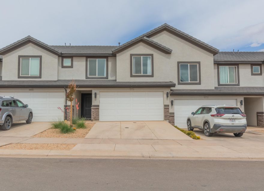 ***FURNITURE NEGOTIABLE*** Discover this quality-built 4-bedroom, 2.5-bath townhome with a 2-car garage in the desirable Long Valley community. Thoughtfully designed layout, featuring a bright open living space and a well-appointed kitchen with a large center island, quartz counters, ample pantry storage, stainless steel appliances, and durable laminate flooring across the main level. Residents enjoy exceptional amenities including resort-style pools, hot tub, pickle-ball courts, an 18-hole putting course, splash pads, and more--perfect for relaxation and recreation. An ideal starter home or excellent second-home investment opportunity. Just a few minutes drive to Sand Hollow State Park and Reservoir. *Buyer is responsible to verify ALL listing information including but not limited to: HOA dues/fees, HOA inclusions, billing companies, transfer fees, acreage, square footage, etc.*