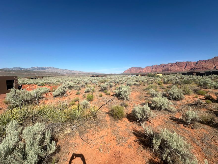 This .53 acre corner lot reflects what Kayenta is all about. Dramatic red mountain views to the north and panoramic vistas to the southwest where you can blend with the natural environment and enjoy the spectacular scenery that the Kayenta landscape has to offer. The Washington County Water Conservancy District Impact Fee has been paid on this lot saving you approximately $13,000 when permits are pulled.