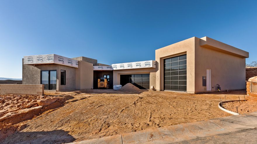 Perched near the top of the gated enclave- Westgate Hills, this single-level home takes in sweeping views of Pine Valley Mtn, sandstone cliffs, city lights & crimson ridges to the south. Set on a private ½-acre lot, it features a 43-ft RV garage w/12'x14' door, 3-car garage & RV pad. Outdoor living shines w/ heated pool, spa, waterfall feature, shamu shelf & auto cover. Inside: 5 beds (5th as office w/view), glass media room, private guest suite with incredible views, a chef's kitchen w/ custom cabinets, high-end countertops & appliances, large working pantry w/southern mountain views + an additional storage pantry. Primary retreat has a large window that perfectly captures Pine Valley Mtn views, has a spa-like bath & spacious closet w/ laundry hookups. Est. completion Jan 2026.