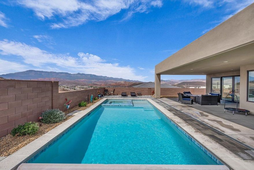 This former builder model home is a showstopper with high-end finishes, perfectly situated on a corner lot with unmatched privacy, a sparkling pool/spa, and a full attached casita. From the living room to the primary suite, the killer 270-degree views of Pine Valley, the red rocks, and even Zion National Park are truly unforgettable. Designer-grade upgrades throughout ensure both style and comfort, starting with an 8-ft metal door entrance and soaring 12-ft ceilings. The gourmet kitchen features Thermador appliances, thick-cut quartz countertops, and a massive hidden walk-in pantry. The primary suite is a true retreat with powered window coverings, a spacious soaker tub, walk-in shower, and a huge master closet. The casita includes its own kitchenette, stackable washer/dryer, and a large walk-in shower, making it perfect for guests or multigenerational living. Outside, the backyard is an entertainer's dream offering a huge, covered patio, pool/spa, and those unbeatable views. The oversized, extra-deep garage could fit 3.5 cars, with additional RV parking and hookups on the side, blending luxury and comfort in one unforgettable package. Buyer to verify all information, deemed reliable, however buyer to verify all info including utilities, rental restrictions, and HOA information if applicable.