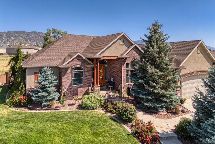 Discover the epitome of luxury, elegance, and comfort in this stunning 6-bedroom, 3-bathroom home, nestled within the Old Farm subdivision. With 4,275 square feet of living space, this residence is perfectly situated at the end of a quiet cul-de-sac, offering both privacy and tranquility. The home boasts stunning stone archways, multiple fireplaces, and a built-in entertainment center, creating a warm and inviting atmosphere. The kitchen is equipped with a pantry, granite countertops, double ovens, and an expansive bar, the kitchen is a chef's dream, perfect for preparing family meals and hosting guests. The home features an abundance of indoor and outdoor storage options, catering to all your family's needs. Multiple garages and storage spaces provide plenty of room to park cars, store toys, or accommodate any other requirements. The roomy attached garage includes 4 parking spaces with extra space for workshop equipment. The detached garage/workshop on the southside of the home has one parking space inside and is 320 sqft. The detached garage on the northside of the home has four parking spaces and is 768 sqft and this driveway can be used for RV parking. Several outdoor seating areas allow you to relax and enjoy the breathtaking views of the surroundings. The beautifully landscaped yard is adorned with mature trees, shrubs, perennials, and rose bushes, offering a picturesque setting for outdoor enjoyment. This home is a true gem, offering a blend of luxury and functionality, making it an ideal choice for families seeking a harmonious living environment.