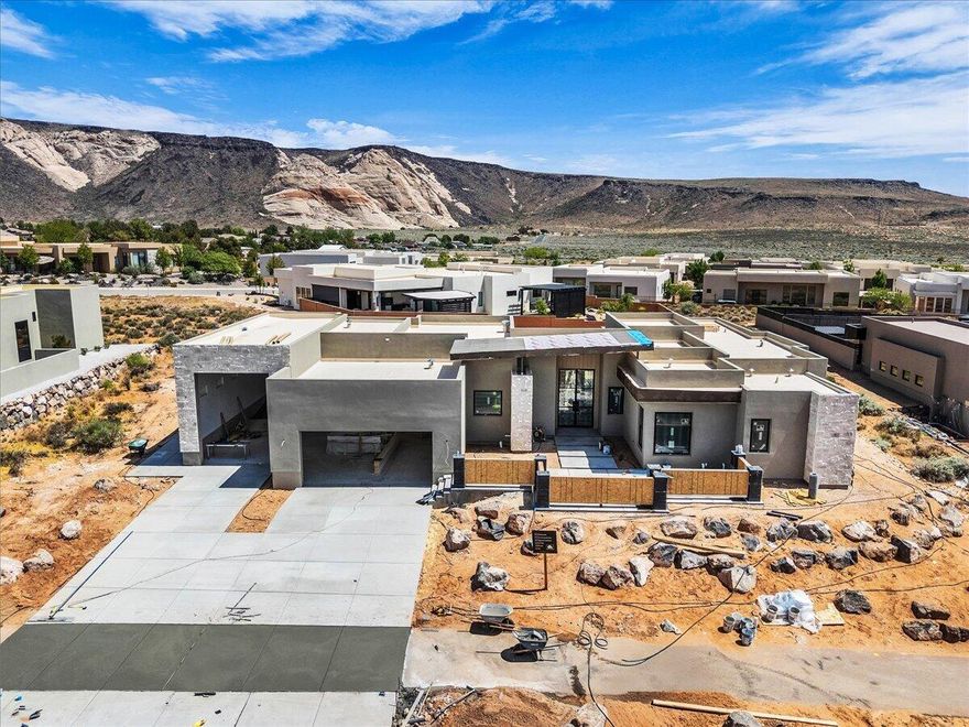 Welcome to this brand-new luxury home in the Ledges, offering breathtaking views and elevated desert living at its finest. Thoughtfully designed with expansive windows that flood the home with natural light. The open concept layout showcases beautiful hardwood flooring, custom cabinetry, high ceilings, wood beams and more!  Quality attention to detail throughout! The primary suite is a true retreat with fireplace, complete with a spa inspired bathroom featuring an oversized walk in shower. Each guest bedroom includes a private bath for added comfort and privacy. Step outside to your desert oasis with a private pool & spa. This exceptional property offers the ultimate living luxury living experience.