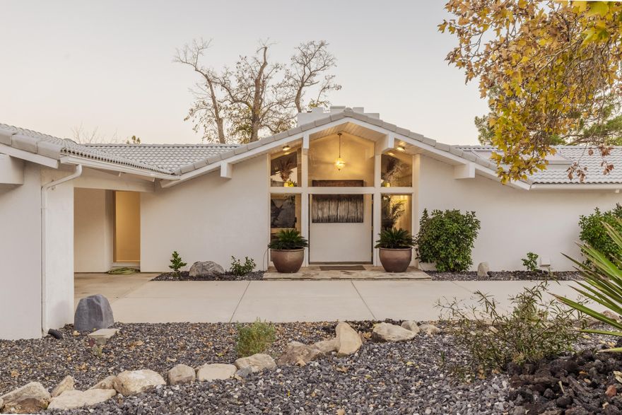 Welcome to a striking transformation of mid-century modern living — a 1970s rambler brilliantly reimagined for 2025. Nestled in a serene golf course community, this 2,140 sq ft, 2-bedroom, 2.5-bath + dedicated office residence blends bold design, thoughtful function, and an atmosphere that simply feels like home. From the moment you enter, prepare to be impressed. Vaulted ceilings, a stunning wood-burning fireplace, and sleek concrete flooring set the tone for sophisticated comfort. Natural light pours in from skylights and double-pane windows, illuminating each carefully curated finish. The chef-inspired galley kitchen is a masterpiece — oak cabinetry, premium electric range, honed quartzite countertops, and a farmhouse sink with an unlacquered brass faucet that will only grow more beautiful with time. Entertaining flows effortlessly between kitchen, dining, and living spaces.

The bedroom suites redefine relaxation. The primary retreat showcases a dramatic rock feature wall, custom closets as well as new closet doors. The guest suite impresses with tailored storage and warm design. All three bathrooms are refreshed with style  including a completely remodeled 3/4 bath featuring tiled walk-in shower, stone accents, new cabinetry, and a Toto toilet seat.
Working from home? The private office delivers comfort and productivity with new built-ins and a mini-split system for year-round climate control.

Step outside to enjoy new low-maintenance landscaping, a peaceful oasis with a covered patio perfect for dining al fresco or winding down under the stars. The sliding glass doors create both ease and elegance in everyday living.

Every major home comfort has been updated for peace of mind:
-New HVAC & heat pump
-Central air + mini-split
-New washer & dryer
-New water softener + filter
-New lighting
-New garbage disposal

Practicality continues with covered parking for 2 vehicles, a dedicated golf cart garage, or may be used as a workshop for projects and hobbyists.

This is more than a home  it's a rare opportunity to own a timeless 1970s architectural gem elevated with today's most desired amenities. The current owner has thoughtfully invested in upgrades throughout 2024-2025, making this property completely move-in ready.

Come experience the WOW for yourself  the beauty and value must be seen to be believed.