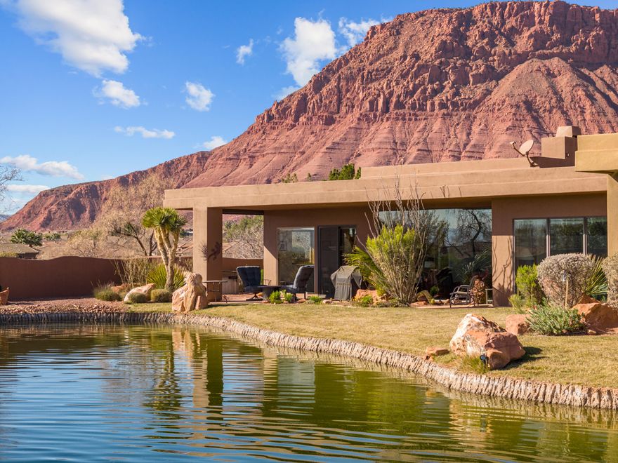 The Springs at Snow Canyon, a quaint gated community features this beautiful home that combines elegance and peace. Quality built in 2004, this well-kept property has timeless charm and stunning scenery. Inside, you'll find three large bedrooms with their own en-suite bathrooms, providing personal retreat for relaxation. The spacious living areas, with a cozy fireplace and views of a lovely water feature make it easy to entertain guests. The open layout leads to a gourmet kitchen equipped with high-end appliances and custom cabinets. Enjoy the convenience of outdoor living and red mountain views from the front courtyard.
Furnishing package is negotiable.  Community is near the entrance of the majestic Snow Canyon State Park, Tuacahn musical plays and the farmers market, Dine, Golf and treat yourself to a spa at the Black Mountain Resort.