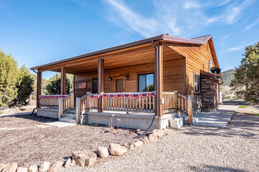 This 1,200 sq ft single-level cabin offers 2 bedrooms and 2 full bathrooms on 2 acres bordering Dixie National Forest. The property is well-treed and attracts regular wildlife, creating a quiet, private setting with direct access to outdoor recreation. The interior features an open living and dining layout with a gas fireplace, providing a functional and comfortable main living space. Both bedrooms are well-sized, and the two full bathrooms add convenience for guests or shared use. The home is equipped with in-floor heating, mini-split air conditioning, and a water softener for year-round comfort.
Outside, the property includes a 16x24 shop suitable for storage, equipment, or projects, along with a 9x12 bunkhouse that can be used for guests or additional space. A separate storage shed adds further utility. Furniture is negotiable, offering a move-in ready option if desired.