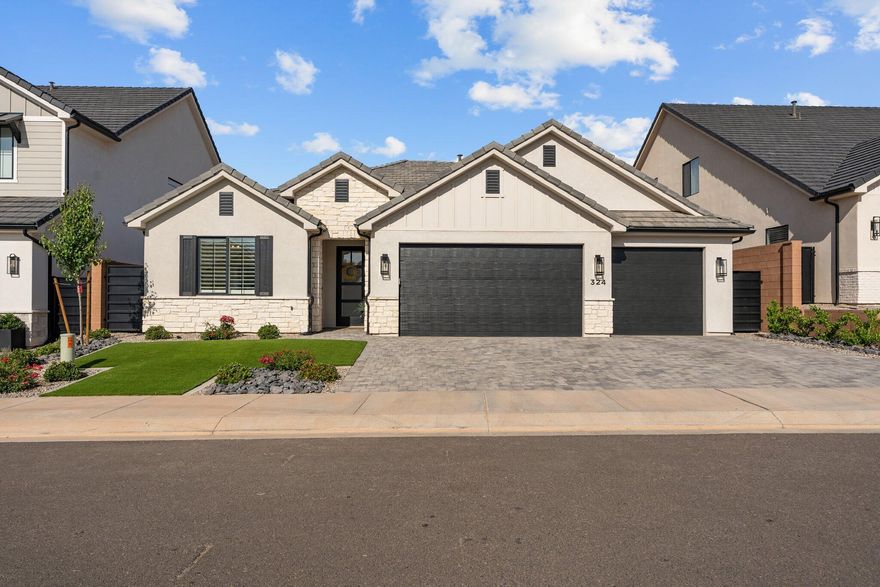 Located in the desirable Red Mesa Subdivision and powered by highly sought-after Dixie Power, this beautiful home features 9 ft ceilings and an open, airy design. The interior offers wood flooring, custom cabinetry, and stylish tile finishes. Oversized, cased windows fill the home with natural light, complemented by plantation shutters and electric blinds on the rear windows. The kitchen includes a full suite of GE Cafe appliances with the refrigerator included. Enjoy outdoor living with a private hot tub, fully landscaped yard with block walls, iron gates, artificial turf, and mature plants. A paver driveway and patio, epoxied garage floor, and water softener add the perfect finishing touches.