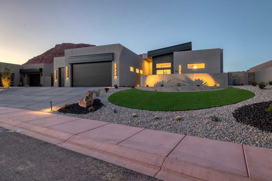 Welcome to your dream oasis nestled in the heart of Ivins! This new construction home is amongst the final gems to be built in The Palisades at Snow Canyon. Boasting a stunning desert contemporary design and top-tier finishes, this 4-bedroom , 3.5-bathroom home offers jaw-dropping views of Red Mountain and The Vermillion Cliffs! The master suite with a custom sauna welcomes you every day.  Spacious 3 car garage.  Imagine lounging by an incredible private pool, warmed by dancing fire features--sounds like a permanent vacation, right? As part of a gated community, enjoy access to a clubhouse, pool, spa, and an exercise room, not to mention 5 pickleball courts, 2 tennis courts and a basketball court.