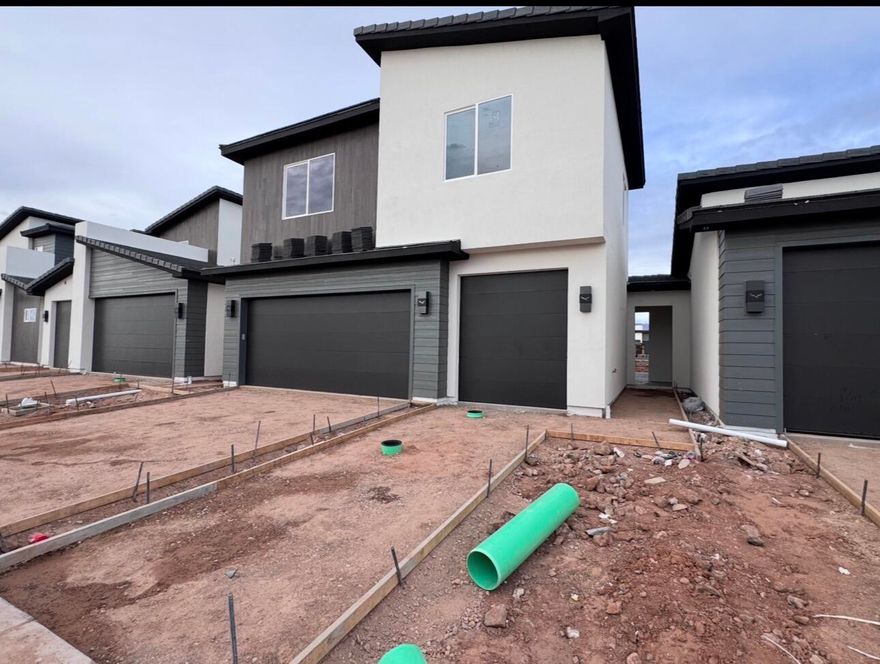 Postcard-perfect panoramas of Zion, Sky Mountain Golf Course, and Pine Valley Mountain greet you daily from the upstairs balcony and loft, views that sell themselves.
Inside, 20' ceilings and an elegant fireplace define the airy great room. The open layout flows effortlessly to a private courtyard, your personal outdoor escape.
Chef's kitchen shines with GE Profile appliances, quartz counters, and soft-close cabinets. Instant hot water via tankless recirculation.
Main-floor primary suite: zero-entry tile shower + soaking tub.

Come see the views. Stay for the lifestyle.