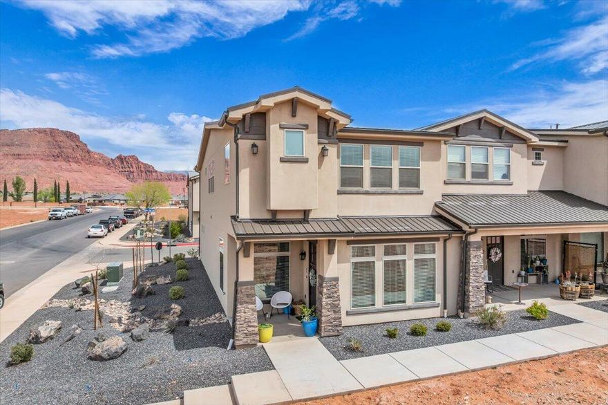 This stunning upgraded end unit boasts breathtaking views of Red Mountains. Features include granite countertops throughout, sleek stainless appliances, stylish two tone paint, 9 ft ceilings on main level, soft close cabinets, LED lighting and fans in every room, large walk in laundry room with built in desk. Large windows throughout that allow plenty of natural light to pour in. 2 Car Garage!  Enjoy easy access to hiking, walking and biking trails. Take advantage of the short distance to grocery store, restaurants, schools, and the picturesque Fire Lake Park at Ivins Reservoir. Community pool & hot tub coming soon.