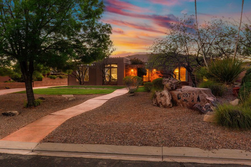 Experience the beauty of Southern Utah living in this stunning Southwest-style home, perfectly positioned to capture breathtaking red rock views. Thoughtfully designed with both comfort and entertaining in mind, this property offers a seamless blend of indoor and outdoor living.

The inviting living room features a striking stone fireplace, creating a warm and welcoming focal point. A dedicated theater room provides the perfect space for movie nights and entertaining.

Step outside to an exceptional outdoor setting, complete with an expansive patio and a large yard designed for both relaxation and play. The private pool, featuring a fun slide, adds a resort-style touch that's perfect for enjoying sunny desert days.

The home's charming courtyard entry enhances its Southwest character, offering a peaceful and stylish introduction to the space within.

With its unique architectural details, incredible views, and standout amenities, this home delivers the ultimate Southern Utah lifestyle.