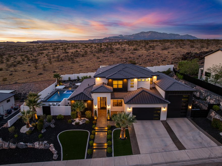 No rear neighbors. Backs directly to Red Cliffs National Conservation Area with open desert and mountain views.

Pool and hot tub with Shamu shelf, crushed quartz epoxy decking, stucco privacy walls, and plush landscaping create a true backyard oasis.

5 bedrooms, office, upstairs family room, and covered deck. Hidden storage room above the RV garage.

Kitchen features double ovens, drop-in cooktop, quartz countertops, large island, and custom cabinetry. Gas fireplace with built-ins. Main-level primary suite with double vanity, soaking tub, and walk-in tiled shower.

38 ft deep RV/boat garage (approx. 12' wide x 14' tall door) plus gated side parking. Ceramic-coated windows with lifetime warranty, water heater booster, whole-house surge protector, and 3 HVAC systems. Minutes from restaurants, shopping, hiking and biking trails.

Occupied. Shown by appointment only.

All information deemed reliable; buyer to verify.