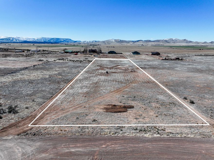 Discover this 2-acre residential lot in the Enterprise Ranchos Subdivision in the rural town of Enterprise, UT. This property includes a 700 ft well equipped with a 7 VFD pump system and comes with 1 acre-foot of water. Enjoy stunning mountain and valley views and ample space for your horses. The lot is conveniently situated just 40 minutes from St. George or Cedar City. Power and gas utilities can be accessed from Bench Road, approximately 730 feet away. A septic system will need to be installed. With Newcastle and Enterprise reservoirs nearby, this is an excellent location for country living with easy access to outdoor recreation!