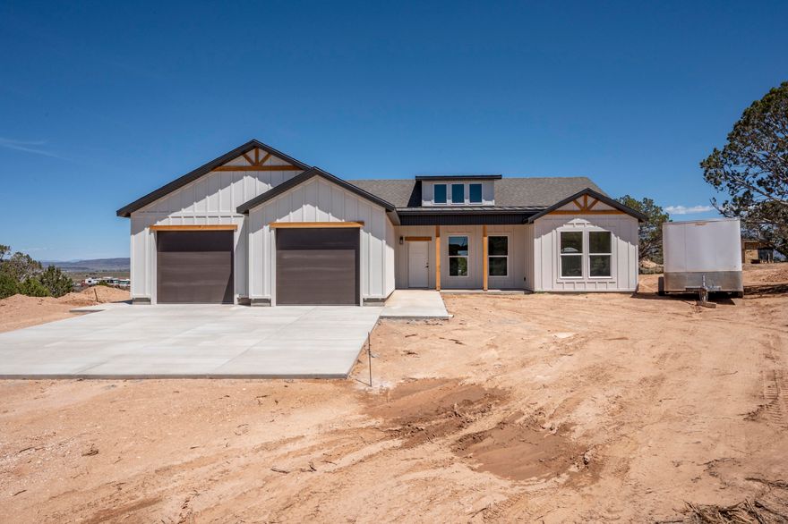 Enjoy country living in this beautiful new construction home situated on 1.25 acres in a peaceful rural setting with animal rights and plenty of room to spread out. This 3-bedroom, 2-bath open concept home offers quality finishes throughout, including custom cabinets, granite countertops, durable LVP flooring, and beautiful custom details. The spacious primary suite features a stunning tile shower with double sinks, double shower heads, and a relaxing soaker tub. You will love the rough sawn exterior details, board and batten Hardie siding, large covered patio and stucco exterior. Bring your RV, trailers, toys and animals-there is ample parking and space to create your own mini farm or hobby property! Comes with .5 acft of water on a shared well.