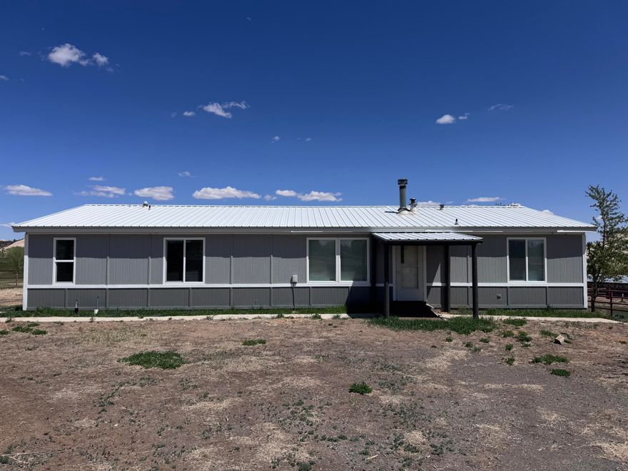 HUGE Price Reduction-way below market value. Rare find. Recently remodeled and move-in ready, this charming 3 bed, 2-bath manufactured home offers 1,585 sq ft of stylish comfort on a sprawling 6.49-acre lot. Rare find in Boulder with incredible 360 degree views! Perfect retreat for nature lovers. Just minutes from Grand Staircase-Escalante National Monument, enjoy world-class hiking, fishing, and endless outdoor adventure right at your doorstep. This property includes valuable irrigation shares, ideal for gardening, livestock, and more. With room to roam and relax, this property offers the best of rural living and epic exploration!  Easy access to Burr Trail and famous slot canyons. Home is turn-key with spacious kitchen with island, new pellet stove, new furnace, newer appliances, barn-door, metal roof, updated cabinets, flooring & much more!  Situated in town with incredible views of Sugarloaf, and Boulder Mountain, this parcel is perfect for your recreational getaway or full-time residence. Bring your horses, RV, hiking shoes, and camera to start enjoying peaceful living with dark skies and fresh air. Call for details and to make an appointment to preview this incredible property today.