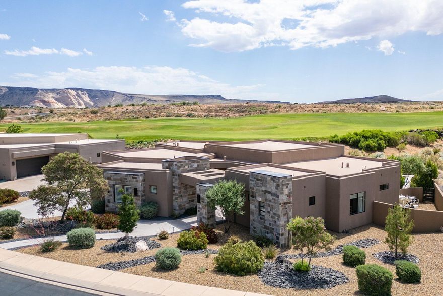 Absolutely stunning home in the gated community of the Ledges of Saint George with unobstructed views of the 16th fairway, and the beautiful white rocks of the Red Cliff National Conservation Area. Enjoy the surrounding striking views from almost every room through the tall panoramic windows. At the entrance, you are welcomed by a nicely secluded courtyard that leads into the home. The open floor concept combines elegant contemporary high-end finishes with timeless warm tones. The tall ceilings and windows allow you to soak in every single ray of light with the elegantly finished fireplace and entertainment center built-ins with wide ship plank backsplash. The wide LVP Hardwood floors lead you into the beautifully designed kitchen with quartz countertops, built-in refrigerator, double ovens, large pantry, floor-to-ceiling cabinets, large kitchen island with sink, contemporary high-end light fixtures, primary bedroom with tall windows, large walk-in shower with a soaking tub inside, and extra roomy closet. Other amazing features in the home include 4 spacious bedrooms including the casita, 4.5 bathrooms, separate office, 3 car garage with 1,159 SqFt of space, large laundry room, and all of this on 0.37 acres. Retreat to your very own exterior oasis with a great pool that features a shamu shelf, waterfall feature, fire feature, and spa. The recently completed outdoor kitchen features a built-in barbeque, bar area, and TV system. Enjoy the most breathtaking sunrises by your built-in fire pit or watch the sun glisten as it bathes the mountains to the east with its shine in the evening. There is no better way to stay cool in the warm summer than to have your yard facing the correct way. Furniture Package Available.

On the bench above Snow Canyon State Park, less than 15 minutes north of the city of Saint George. This property is also a short drive to some of America's most breathtaking destinations, including Zion National Park, Bryce National Park, and the north rim of the Grand Canyon. Other nearby state parks and national forests, include Sand Hollow Reservoir, Gunlock Reservoir, Quail Creek Reservoir, and Dixie National Forest that enhance the allure of the location. With over 300 days of sun, incredible year-round weather, and in the middle of a 7,200 yard par 72 golf course designed by Matt Dye, there is no doubt that The Ledges is one of Southern Utah's best kept secrets. One of the best places to live for those that love the outdoors, biking, hiking, fishing, ATVing, and all other high-desert adventures.

All information herein is deemed reliable but is not guaranteed. Buyer is responsible to verify all listing information, including square feet/acreage, to buyer's own satisfaction
