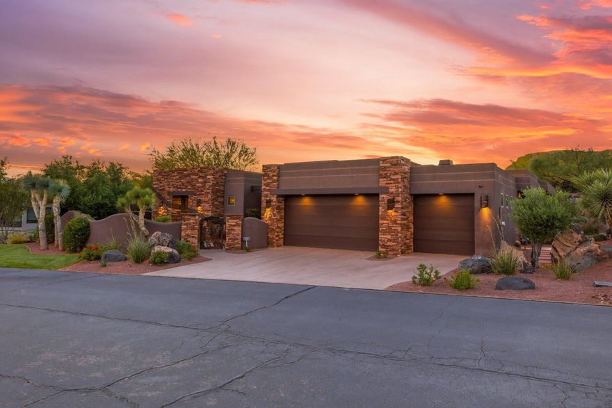 Situated within the prestigious gated community of The Reserve at Entrada, this exceptional luxury residence offers an extraordinary blend of privacy, elegance, and breathtaking desert beauty. Built in 2007, the 3,894-square-foot estate is thoughtfully designed to capture stunning red rock views while creating a serene retreat both indoors and out.

The home features three spacious en-suite bedrooms, a beautifully appointed powder room, and a private office complete with hidden storage concealed behind a custom, glass shelved bookcase. Rich African mahogany cabinetry is showcased throughout the home, complementing the warm architectural details and timeless craftsmanship.

Expansive floor-to-ceiling windows flood the interiors with natural light and seamlessly connect the living spaces to the surrounding landscape. Three indoor fireplaces create an inviting atmosphere throughout, while the chef's kitchen is enhanced by a functional butler's pantry designed for effortless entertaining.

The primary suite serves as a private sanctuary, featuring a luxurious steam shower, therapeutic air tub and a separate laundry area conveniently located within the closet.

Outdoor living is equally captivating. The private backyard is centered around a tranquil pond with two beautiful waterfalls, creating a calming ambiance alongside the in-ground jacuzzi, built-in outdoor BBQ, and cozy gas fire pit. In the front and side courtyards, two elegant water fountains welcome guests with timeless sophistication.

Combining refined luxury, unmatched privacy, and iconic Southern Utah scenery, this remarkable residence offers an elevated lifestyle in one of the area's most exclusive communities with access to the prominent Entrada Golf Club.

Please allow 2 hour notice prior to showings.