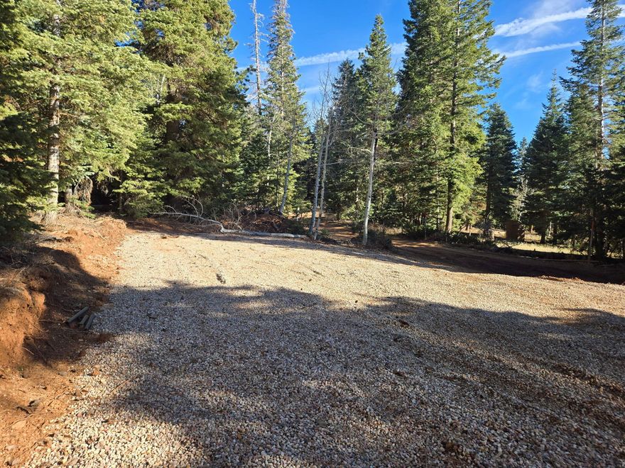 5465 W Berry Loop, Lot 56, Navajo Lake Estates - Duck Creek Village, UT
This serene 0.50-acre wooded lot offers a private mountain retreat in Navajo Lake Estates near Duck Creek Village. Mature trees line the road, creating a peaceful, scenic setting at high elevation on the Markagunt Plateau in Dixie National Forest.
Just minutes from Navajo Lake (approx. 9,200 ft), enjoy excellent fishing for rainbow and brook trout, boating, kayaking, swimming, and cool summer breezes -- a refreshing escape from the desert heat. The surrounding forest provides outstanding recreation: hiking the Navajo Lake Loop Trail and Virgin River Rim Trail, ATV riding on the Markagunt OHV system, mountain biking, wildlife viewing, and photography. Easy day trips to Cedar Breaks National Monument, Bryce Canyon, and Zion National Park.
Ideal for off-grid or seasonal use. Water is hauled from a natural spring only about 2 miles away for convenient tank refills. Power via solar or generator. The lot has already been excavated and graveled with over $10,000 in site improvements, making it ready for immediate RV use, glamping, or future cabin construction.
Duck Creek Village, at approximately 8,400 ft elevation, is a small mountain community offering shops, restaurants, lodges, and access to year-round adventures in Southern Utah's high country. Road access in Navajo Lake Estates is typically seasonal (generally April-November), aligning with prime summer and early fall enjoyment.
Whether you seek a weekend basecamp, RV getaway, or cabin site, this parcel delivers location, recreation, and tranquility.