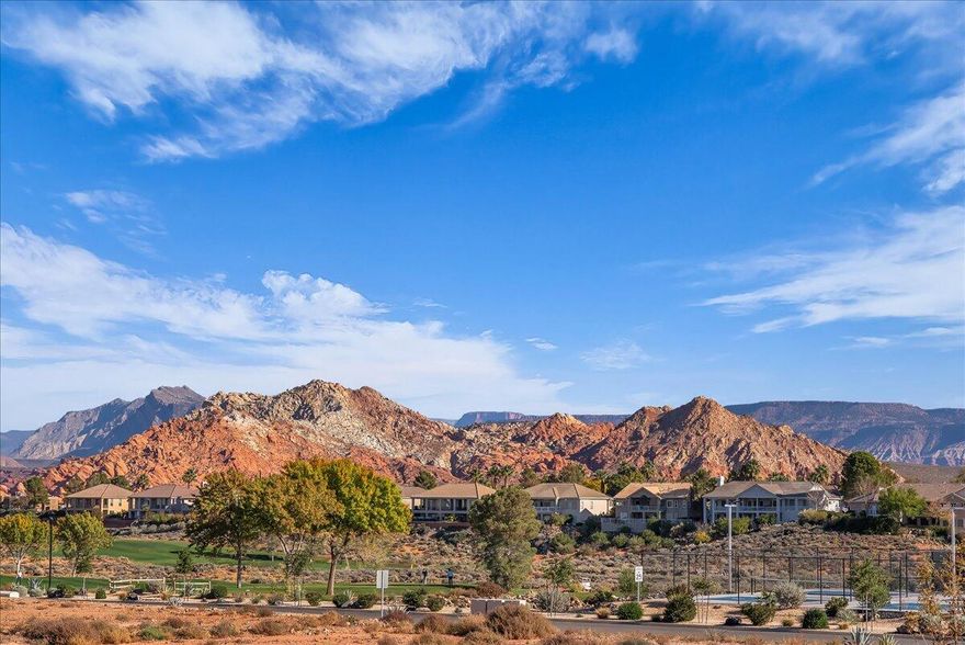 Relish & live it up in your own 2 story townhome immediately adjacent to the Sky Mountain golf course. Overwhelming views of red rocks & green grass from the upstairs deck. Over 2000 sf, 4 generous size bdrm.'s, 2.5 baths. The primary suite is on the main level. DOUBLE family rooms offer separate areas for adults & kids to enjoy their favorite games, favorite shows and favorite friends. Squeaky clean as if Mr. Clean just left. No dings, no scratches and no vanilla. You'll most definitely see the difference between between vanilla vs the best tasting desert. Residents enjoy resort-style amenities such as an outdoor pool, pickleball courts, & front yard care. An undisturbed private picnic area you'll share with friends, family & neighbors on the north pointe. Poised for anyone's lifestyle.