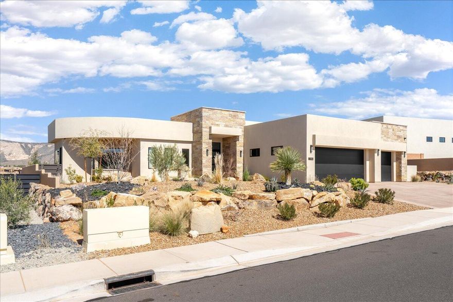 Stunning Desert Modern Retreat in The Ledges of St. George. Welcome to 1392 Canyon Tree Drive, an exceptional home nestled in the highly sought-after Ledges community of St. George, Utah. Perfectly positioned on the tee box of Hole 9, this property captures truly incredible, unobstructed views of the golf course and the striking red rock mountains of Snow Canyon State Park--offering a setting that is both peaceful and visually unforgettable. Step inside to discover a thoughtfully designed open-concept floor plan filled with natural light, soaring ceilings, and high-end finishes throughout. The gourmet kitchen is a true centerpiece, featuring sleek countertops, premium appliances, custom cabinetry, and a spacious island perfect for entertaining. The living area seamlessly connects to the outdoor space, where you'll find a private backyard oasis ideal for relaxing or hosting guests. Whether enjoying your morning coffee or an evening gathering, the elevated vantage point overlooking Hole 9 provides a dynamic backdrop of lush fairways and dramatic desert scenery. Adding to the home's versatility is a private casita with its own separate entrance--perfect for guests or extended family. The casita includes a convenient kitchenette area complete with a refrigerator and sink, creating a comfortable and self-contained living space. The primary suite is a peaceful retreat, complete with a spa-like ensuite bathroom, walk-in shower, and generous closet space. Additional bedrooms provide flexibility for guests, family, or a home office. Oversized 3 car garage complete with heating and AC. Located in The Ledges, residents enjoy access to world-class golf, scenic hiking and biking trails, and close proximity to Snow Canyon State Park. This home offers unparalleled access to the best of Southern Utah living.