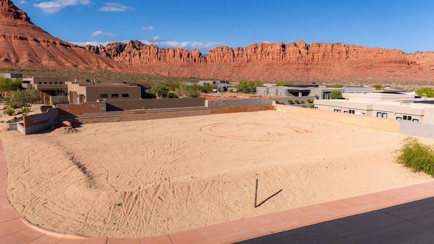 Indulge in the pinnacle of luxury living in an exclusive gated enclave bordering State Park land! This rare .42-acre lot is one of the last available close to the rim, offering breathtaking red rock views and unparalleled access to nature's splendor. Unleash your adventurous side on miles of hiking and biking trails at your doorstep, or tee off at world-class golf courses nearby. Catch a show under the stars at Tuacahn Outdoor Theater, renowned for its spectacular concerts and productions. Enjoy elevated resort-style living with exquisite amenities like a community pool, clubhouse, and multiple Pickleball courts. With remarkably low dues and the freedom to craft your dream estate on this expansive lot, this extraordinary opportunity awaits discerning buyers seeking the ultimate in luxury and seclusion