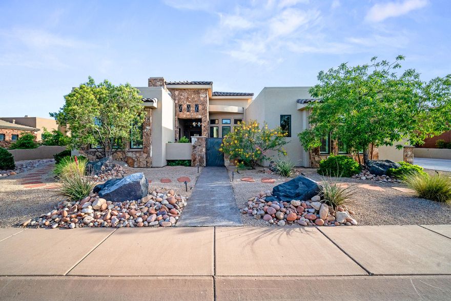 Located in the gated side of The Ledges with security, this exceptional 4-bedroom, 4.5-bathroom home with a den offers luxury living with an open floor plan and stunning natural light throughout. The spacious living room and kitchen feature soaring 12-foot ceilings, creating an inviting and airy atmosphere. The gourmet kitchen is designed for both entertaining and everyday living with a massive 10x5 island and premium Wolf stove. Comfort and convenience are elevated with heated floors in the kitchen, primary bathroom, and guest suite, along with separate temperature control zones in each room. Additional features include a 75-gallon water heater and thoughtfully designed high-end finishes throughout. Step outside to your private backyard retreat featuring a Pebble Tec in-ground pool and spa with an automatic pool cover, fire pit, and the perfect space to relax or entertain while enjoying the beautiful surroundings of The Ledges.