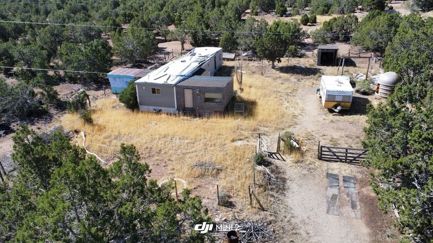 1/2 Acre property just West of Cedar City, surrounded by tall pine trees and beautiful mountain views! Property has utilities available access to community well and septic. The trailer on the property could be fixed up with some love or just hauled away. Building permit will not be issued for this lot.