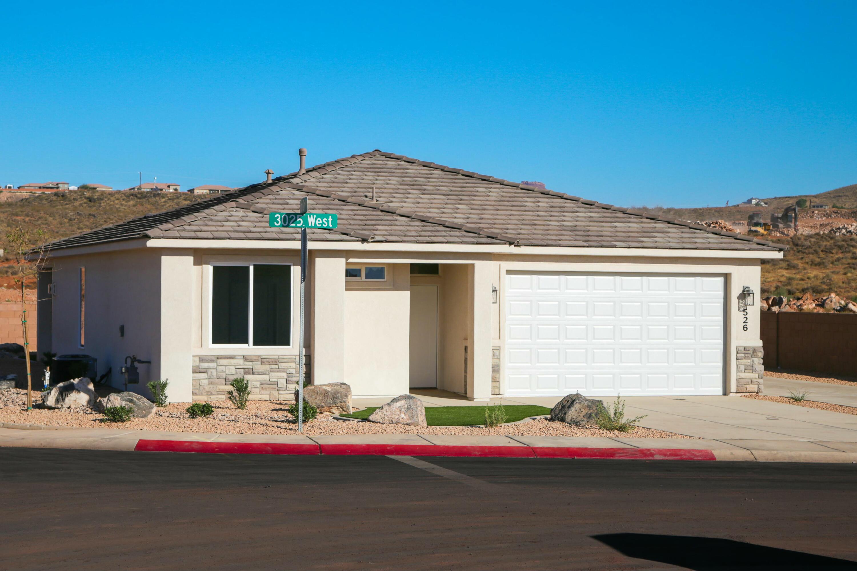 Under Construction! Estimated finish date - June, 2025. This home qualifies for a slew of first time Homebuyer Grants! It features drought-tolerant professionally landscaped front and backyard with a covered patio. Master suite includes spacious walk-in closet and fully tiled walk-in shower. Two car garage is fully drywalled and painted! Stainless sink in the kitchen island, Moen Plumbing fixtures, quartz countertops, and natural Alder cabinetry with soft-close hinges and under-cabinet lights. Loads of cabinet space! Woodgrain tile floors and gas fireplace in living room. Thirty-foot paved RV pad with a powder coated gate, water, 30-amp hook ups + sewer dump! Come in and see us soon to customize the home to your liking. See you soon!