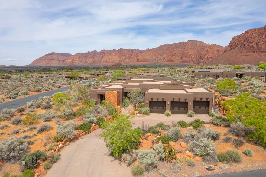 UPDATE: Entire home exterior freshly painted as of April 2026!  Come see this exceptional Kayenta home, built in 2016 by Splitrock Homes, renowed for quality construction using the highest grade of materials, and situated on a .57 acre corner lot with stunning views of both the towering red cliffs to the north as well as the beautiful Beaver Dam Mountains to the southwest. This 3,050 square foot classic contemporary includes an open floorplan, butted floor to ceiling glass windows with picture-perfect views of the Red Mountains and custom-built fireplace, an oversized kitchen with stunning granite countertops, 3 large bedrooms, 3 en-suite bathrooms, a 3 car garage, and 2 outdoor patios (one with built-in BBQ.  The owners retreat offers an oversized closet with plenty of storage space and a bathroom with double vanity and gorgeous copper bathtub. The home is wired for a speaker system throughout, has a cell tower repeater for strong cell phone service, and one of the HVAC units was recently replaced.  
506 is located just a 5 minute drive from the Kayenta Art Village, with its restaurants, galleries, shops and performing arts center, not to mention outdoor swimming pool, pickleball courts, and tennis court.  Enjoy the privacy, tranquility and seclusion, protected night skies and Kayenta lifestyle that 506 Tearasinab has to offer. Come experience for yourself.