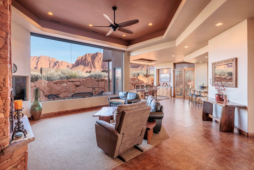 Come see this exceptional Kayenta home, built in 2016 by Splitrock Homes, renowed for quality construction using the highest grade of materials, and situated on a .57 acre corner lot with stunning views of both the towering red cliffs to the north as well as the beautiful Beaver Dam Mountains to the southwest. This 3,050 square foot classic contemporary includes an open floorplan, butted floor to ceiling glass windows with picture-perfect views of the Red Mountains and custom-built fireplace, an oversized kitchen with stunning granite countertops, 3 large bedrooms, 3 en-suite bathrooms, a 3 car garage, and 2 outdoor patios (one with built-in BBQ.  The owners retreat offers an oversized closet with plenty of storage space and a bathroom with double vanity and gorgeous copper bathtub. The home is wired for a speaker system throughout, has a cell tower repeater for strong cell phone service, and one of the HVAC units was recently replaced.  
506 is located just a 5 minute drive from the Kayenta Art Village, with its restaurants, galleries, shops and performing arts center, not to mention outdoor swimming pool, pickleball courts, and tennis court.  Enjoy the privacy, tranquility and seclusion, protected night skies and Kayenta lifestyle that 506 Tearasinab has to offer. Come experience for yourself.