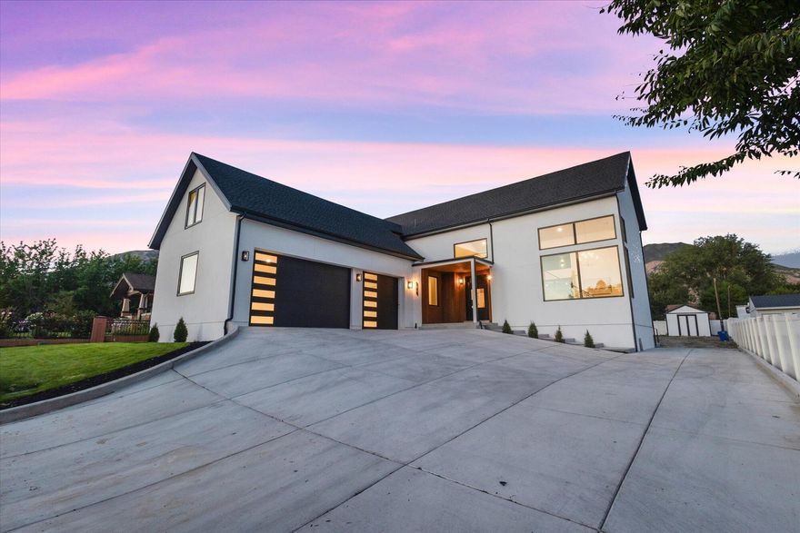 This stunning new home combines modern luxury with thoughtful design and top-of-the-line finishes. At the heart of the home is a dream kitchen with custom white oak cabinetry, Taj Mahal quartzite countertops, a huge 10-foot island, and high-end Sub-Zero, Wolf, and Cove appliances. Expansive European-style luxury Soniq windows fill the space with natural light, while the oversized back deck and upper terrace provide incredible mountain views. A custom floating staircase leads to the upper level, where you'll find a spacious loft, additional bedrooms and bathrooms. The home features dual furnaces for efficient heating and cooling, a separate basement entrance for added flexibility, and sleek, side-mounted garage doors that are as quiet as they are stylish. Located close to shopping, dining, and major commuting routes, this home offers the perfect blend of comfort, style, and convenience.