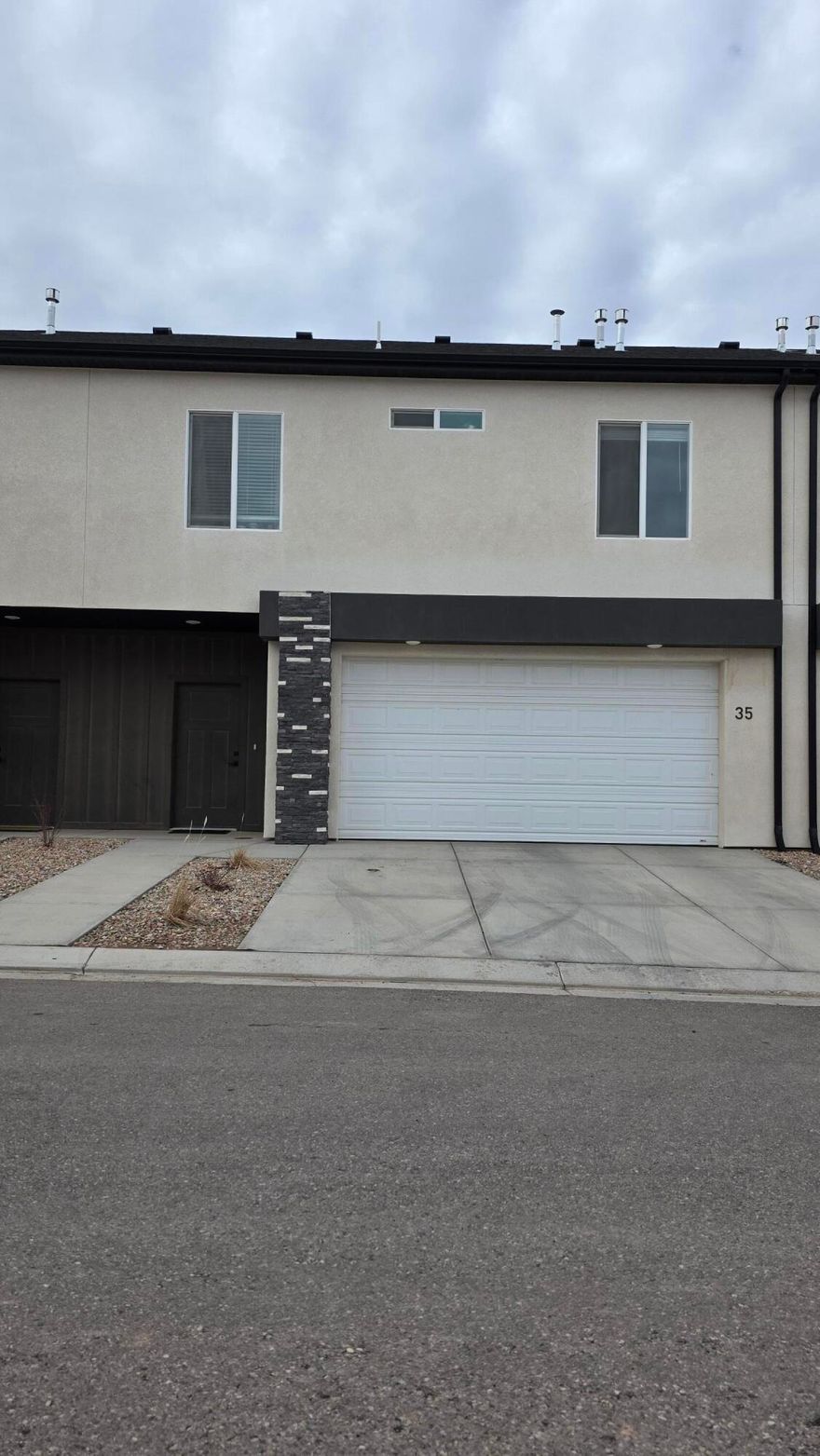 Immaculate, move in ready 3 bedroom 2.5 bathroom townhome with a modern open layout and soaring ceilings that create a bright and inviting feel. This newer home offers high speed internet, excellent natural light, and a spacious design that lives larger than expected. The kitchen features quartz countertops, stainless steel appliances, a large walk in pantry, and opens to the living area with a cozy fireplace. LVP flooring on the main level with carpet on stairs and upper bedrooms. The primary suite includes great storage and a spacious ensuite bath. West units offer a larger backyard, and this home has more outdoor space than many surrounding units. Walking distance to trails, shopping, and the fairgrounds. Ideal for first time buyers, vacation home, or short term rental. A must see!