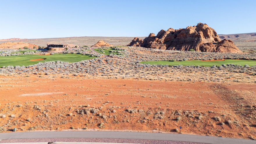 Exclusive golf course living at its finest. Lot 56 sits directly on the tee box of Hole 10, the opening of Sand Hollow's celebrated back nine -- one of Golfweek's Top 100 Resort Courses in the United States. At slightly over three-quarters of an acre with a flat, pad-ready homesite, this is a rare opportunity to build a luxury custom residence at Southern Utah's most sought-after address. The Estates has hosted multiple Parade of Homes events, with showcase residences selling to buyers who recognize this as the region's premier community.

From your backyard, watch golfers tee off while taking in direct views of the resort clubhouse, the Hole 9 green, and a dramatic sandstone formation at the lot's edge that no builder could replicate. Facing west, the property captures open desert sunsets every evening. Directly across the street, Sand Hollow State Park offers reservoir boating and a sandy beach within minutes. Zion National Park, Brian Head Ski Resort, and Lake Powell are all within easy reach for year-round adventure.

The region is thriving -- a new hospital, Hurricane schools, and two destination resort developments with water parks are all underway nearby. Ownership includes the exclusive Sand Hollow Clubhouse, seasonal pools, fitness center, The Grille, and HOA-covered landscaping and hourly security patrol. Homeowner perks include 40% off Championship Course green fees, discounts on The Links, the Pro Shop, The Grille, and 10% off Mad Moose UTV and watercraft rentals on property.

The lot accommodates an estate-style home, resort pool, casita, and oversized garages. Premier approved builders available, or bring your own. 15 minutes to St. George Airport. 90 minutes to Las Vegas.