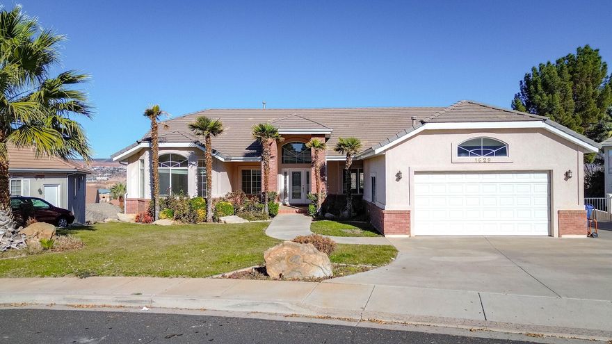 This spacious 4,987 square foot walkout basement home in the desirable Boulders subdivision offers exceptional flexibility, views, and value. Featuring two full kitchens, the lower level is ideal for a separate ADU or mother-in-law apartment, perfect for multigenerational living or rental potential. Expansive great rooms on both the main level and basement provide plenty of space for entertaining, relaxing, or gathering with family and friends. Enjoy sweeping panoramic views stretching from the Black Hill across Pine Valley Mountain and all the way to the city of Washington. The Boulders subdivision offers outstanding amenities including a pool, pickleball courts, tennis courts, and a basketball court. Conveniently located near a wide variety of restaurants, grocery stores, and other commercial outlets, this home combines size, location, and opportunity. While the home is in great overall condition, it does need updating, and it is priced accordinglymaking it an excellent opportunity to customize and add value in a highly sought-after community.